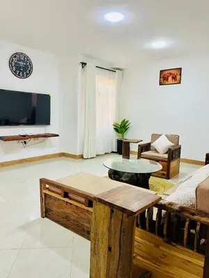 a living room with a couch and a table at Urban Nest in Arusha