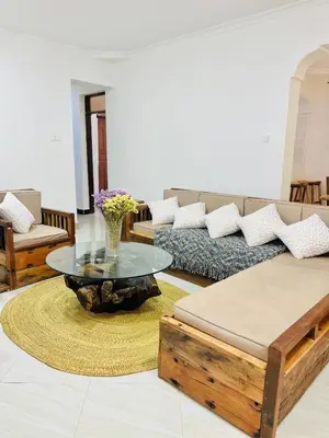 a living room with a couch and a glass table at Urban Nest in Arusha