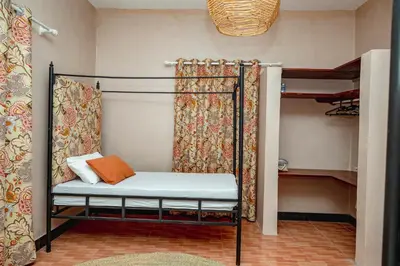 a room with a bed and a bunk bed at Ghala House Apartment Moshi in Moshi