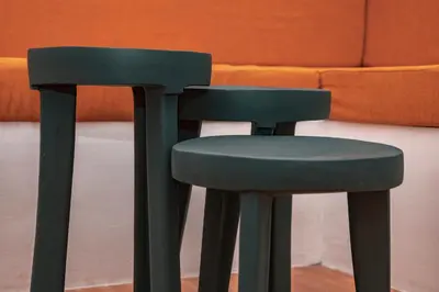 a green stool sitting in front of a couch at Ghala House Apartment Moshi in Moshi