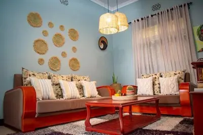 a living room with a couch and a table at ILBORU HAVEN HOMEs in Arusha