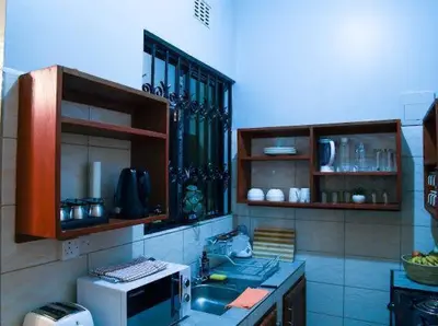 a kitchen with a microwave and a counter top at ILBORU HAVEN HOMEs in Arusha