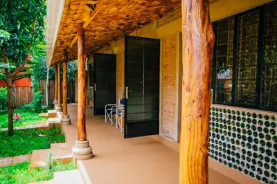 a porch of a house with a wooden roof at Misitu Eco-Lodge in Karatu