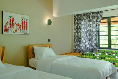 a bedroom with two beds and a window at Misitu Eco-Lodge in Karatu