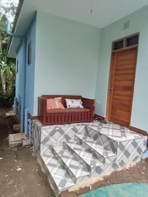 a couch sitting on the side of a house at Vanilla coffee farm lodge campsite in Arusha