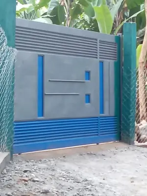 a blue and white garage door on a fence at Vanilla coffee farm lodge campsite in Arusha