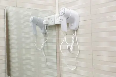 a couple of white phones hanging on a wall at Diamond Delight Boutique Hotels in Moshi