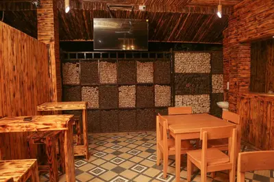 a dining room with tables and chairs and a television at Diamond Delight Boutique Hotels in Moshi