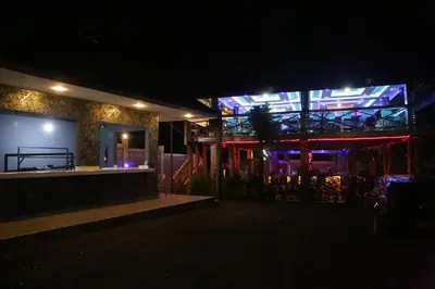 a night view of a building with a large screen at Diamond Delight Boutique Hotels in Moshi