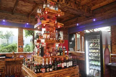 a bar with a bunch of bottles of wine at Diamond Delight Boutique Hotels in Moshi