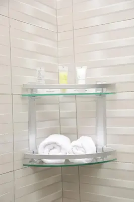 two towels and two cups on shelves in a bathroom at Diamond Delight Boutique Hotels in Moshi