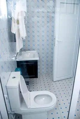 a bathroom with a white toilet and a sink at VvEK B&B APARTMENT in Arusha