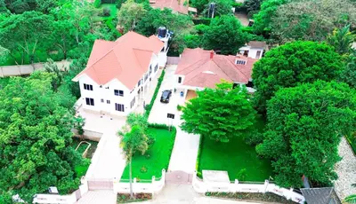 an aerial view of a large house with a red roof at VvEK B&B APARTMENT in Arusha