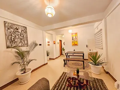 a living room with potted plants and a table at Fly Africa Village 2 in Arusha