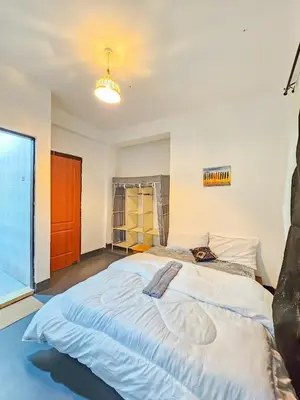 a large bed in a room with a large window at Fly Africa Village 2 in Arusha