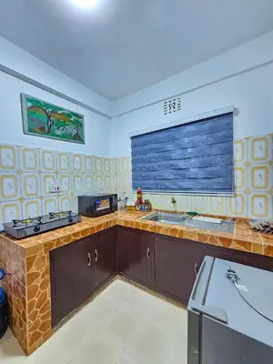 a kitchen with a sink and a large window at Fly Africa Village 2 in Arusha