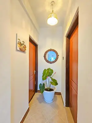 a hallway with a plant in a white pot at Fly Africa Village 2 in Arusha