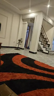 a room with a rug on the floor and a staircase at SEBA & Cherise in Usa