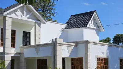 a white house with a black roof at SEBA & Cherise in Usa