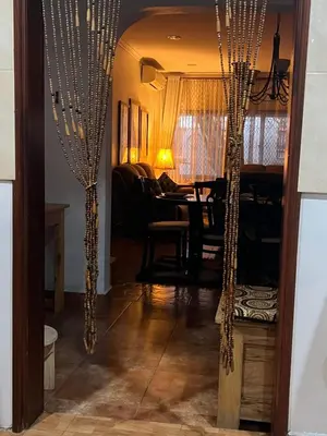 a dining room with christmas lights and a table at JDs Home in Arusha