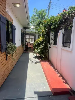 an empty hallway of a house with a red sidewalk at JDs Home in Arusha