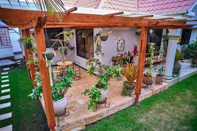 a pergola with a bunch of potted plants at Lavish Luxury Homes in Tengeru