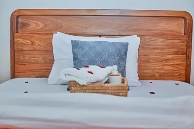 a bed with a towel and a basket on it at Lavish Luxury Homes in Tengeru
