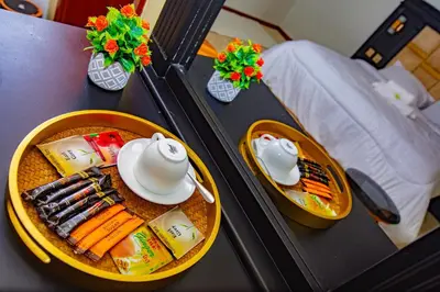 a table with a plate of food and dishes on it at Divine Royal Residences in Arusha