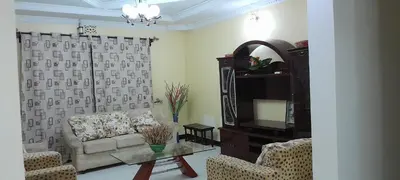 a living room with a couch and a tv at December apartment in Sokon