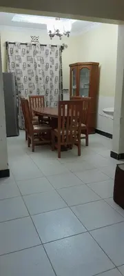 a dining room with a wooden table and chairs at December apartment in Sokon