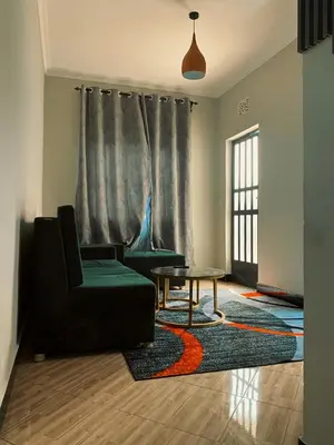 a living room with a couch and a table at Kanyigo homes in Arusha