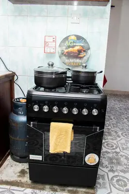 a stove with two pots and pans on top of it at Meru Villa Arusha in Olmotoni
