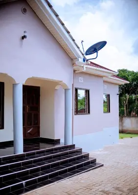 a house with a satellite on the roof at Tembo Homestay in Arusha
