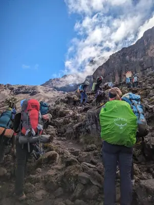 a group of people with backpacks on a mountain at Rafiki Backpackers & Guesthouse in Moshi