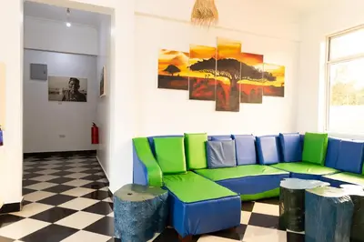 a living room with a blue and green couch at Rafiki Backpackers & Guesthouse in Moshi