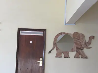 a wooden door with a mirror next to it at Equator Hotel in Arusha