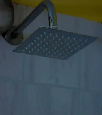 a strainer in a sink in a bathroom at Equator Hotel in Arusha