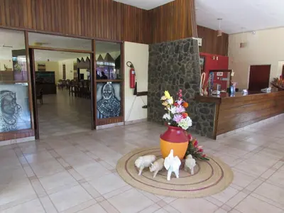 a lobby with a vase with animals on the floor at Equator Hotel in Arusha