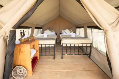 a room with four beds in a tent at Africa Safari South Serengeti Ndutu Camping in Sinoni