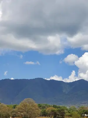 a cloudy blue sky with mountains in the background at Last fantasy ndoto ya mwisho in Arusha