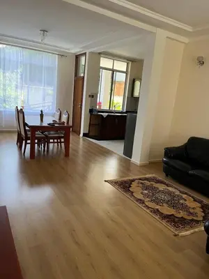 a living room with a table and a couch at Shanti Apartments in Uru