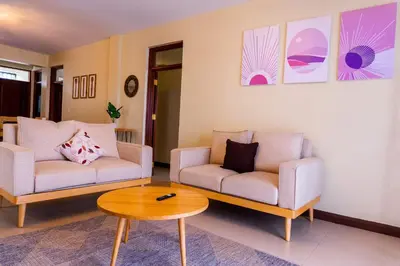 a living room with two couches and a coffee table at Timeless Escape in Arusha