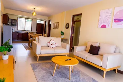 a living room with two couches and a table at Timeless Escape in Arusha
