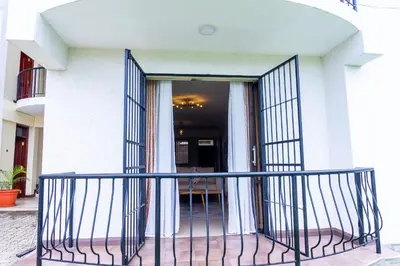 a balcony with a gate in front of a building at Timeless Escape in Arusha