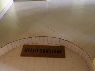 a bowling alley with a hello sunshine sign on the floor at Sofa So Good Backpackers' Nest in Arusha