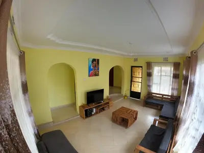 an overhead view of a living room with yellow walls at Sofa So Good Backpackers' Nest in Arusha