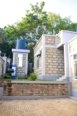 a house with a water tank on top of it at chamber 206 in Arusha