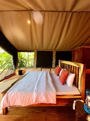 a bedroom with a bed in a tent at Kibo View Farm Lodge in Shiri