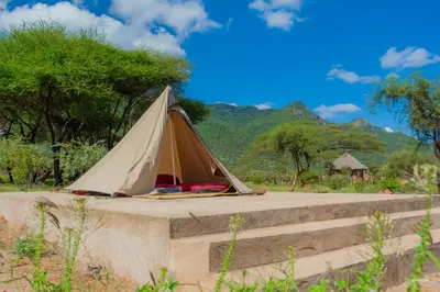 a tent sitting on top of a concrete ledge at Kili View Maasai Lodge in Longido