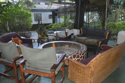 a group of chairs and a fire pit in a yard at Ethiopian restaurant and lodge in Arusha